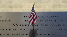 Close Up of USA Flag Flying in 911 Memorial Plaque