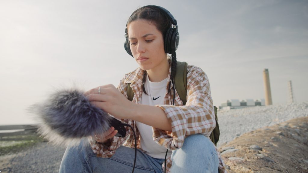 woman with handheld recorder