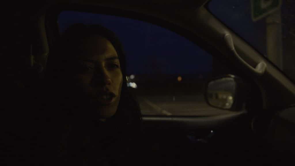 interior car scene at night under a street lamp